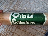 Close-up of wallpaper roll label showing "Oriental Collections" brand.