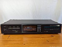 Front angled view of the Sansui Model T-700 AM/FM tuner showing the digital frequency display and tuning indicators.