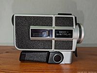 Side view of vintage Yashica Super YXL-1.1 Super 8 video camera showing textured grip and model name.
