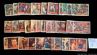 Overview photo of 58 Robin Hood Topps trading cards laid out in rows, showing fronts with colorful illustrated scenes.