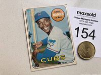 Front of 1969 OPC Ernie Banks baseball card, showing photo of Banks in Cubs uniform with bat, card number 20, name, and team logo.