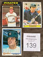 Close up photo showing detailed view of three baseball cards including Danny Murtaugh of the Pirates, Rusty Staub of the Tigers, and Lou Piniella of the Yankees.