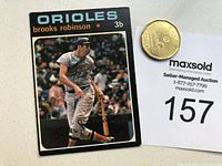 Front view of 1971 OPC Brooks Robinson baseball card with black border, player image, and text.