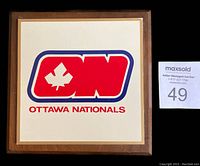 Front view of the square wooden plaque featuring the 1972-73 Ottawa Nationals logo in red, white, and blue on a white background with wood frame.