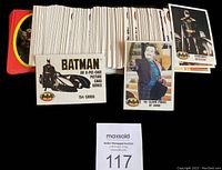 Spread of 1989 Batman movie trading cards showing the fronts with character images including Batman and The Joker, along with the original card packaging.