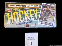 Front view of the sealed 1990 Topps Hockey factory set box featuring card graphics and set information.