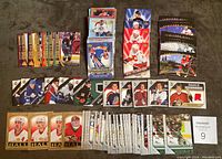 Full view of majority of cards laid out on floor separated by series and types including jersey swatch cards and rookie cards.