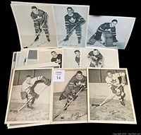 Display of 10 vintage 8x10 black and white photos showing various Toronto Maple Leafs players in hockey uniforms, some signed or titled with player names, including Bill Barilko and others.