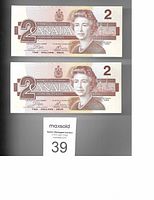 Front sides of two Canadian $2 bills from 1986 showing Queen Elizabeth II portrait, signatures, and denomination