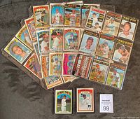 Fanned display of multiple loose cards laid out on gray surface