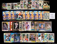 Multiple baseball cards laid out showing various players including Nolan Ryan, Gary Carter, and Rickey Henderson; cards mainly from 1980s and 1990s eras in good condition