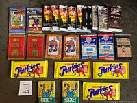 Full overview of all 25 hockey wax packs laid out, showing the variety of brands and years, including OPC, Parkhurst, Donruss, OHL, McDonald's, Ultimate, and Pro Set.
