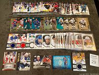 Overview photo showing 60 hockey insert cards from the 2015-16 Upper Deck series spread out on a table, includes various insert types and players.