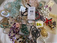 Overview image showing a collection of various costume jewelry items, including beaded necklaces, bracelets, and earrings spread out on a surface.