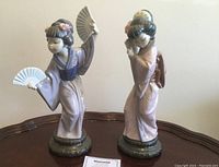Both figurines in full view on table