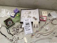 Wide shot showing various bracelets, necklaces, earrings in assortment