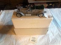 Photo of the 1907 Rolls-Royce Silver Ghost model car displayed on original styrofoam packaging and box.