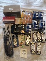 Full overview of the lot showing boxed and loose items including bulbs, outlets, LED lights and zip ties.