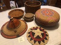Overview of the full collection showing five different handwoven items including baskets in various sizes and a conical hat.