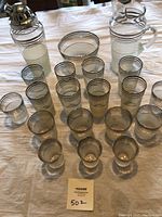 Full set laid out showing all pieces including shaker, pitcher, ice bowl, and varied glasses