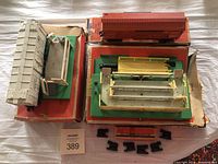 Top view of both train cars on original damaged boxes showing the Milk Car and the Cattle Car with figures.