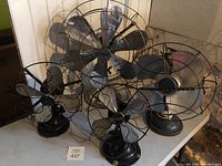 All four fans grouped on a table: Diehl, Westinghouse, Gilbert and one unbranded.