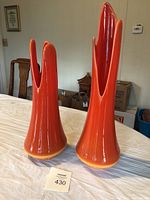 Front view of both orange vases side by side