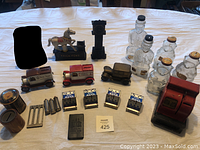 Full lot overview showing various vintage money banks including Trick Pony bank, clock bank, glass banks, metal carriages, dime registers, and more