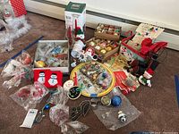 Overview of lot showing various vintage Christmas ornaments, the Currier and Ives tray, and other holiday decorations arranged on carpet.