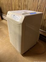 Full view of Kenmore M-51650 dehumidifier from an angle showing off-white plastic body and front vent.