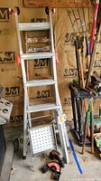 Photo showing Little Giant ladder system with work platform and leg leveler, Werner wooden ladder partially visible to the rear