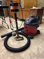 Simer non-submersible pump and Craftsman shop vac set on basement floor, showing hoses and pump float switch