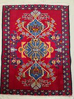 Top-down image of the Persian Ardebil rug showing the detailed pattern and vibrant colors.