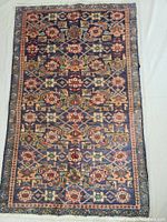 Full top view of rug showing all-over geometric floral Mahi pattern and border.