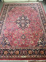 Full view of rug laid flat on floor showing overall design and border