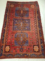 Full view of rug front showing overall triple medallion pattern, border and fringe