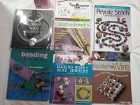 Photo showing all six jewelry making books laid flat, covers visible with titles and some jewelry images.
