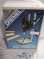 Front side of the box showing product image and brand Dremel Drill Press 212
