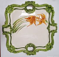 Top-down photo showing the full view of the 16 inch rectangular ceramic serving tray with orange flowers and green ornate handles.