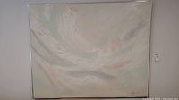 Full view of the framed abstract painting showing the soft textured design and signature bottom right