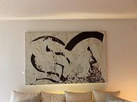 Full view of large abstract oil painting hung on beige wall above sofa with cushions, showing the entire canvas artwork.