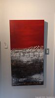 Full view of the vertical rectangular oil on canvas painting with red upper section and textured white and black areas below