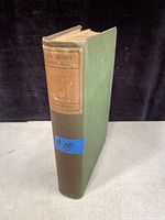 Photo of the antique hardcover book showing green cloth cover and brown spine label titled 'The World's Great Books'.