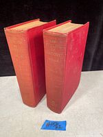 Two red hardcover books standing side by side, spines visible showing titles and author H.G. Wells, volumes 1 and 2.