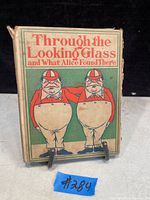Front cover of the antique book showing two characters and the title.