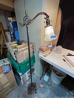 Full view of antique bridge floor lamp showing base, column, adjustable arm, and shade.