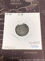 Front side of the 1895 Great Britain silver 3 pence coin showing the crowned numeral 3 with floral decorations and text noting the silver content and coin description.