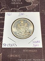 1963 Canadian 50 cents coin showing Canadian coat of arms and details about silver content and denomination.