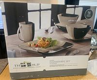 Photo of the boxed Darien Threshold stoneware dinnerware set with 16 pieces.