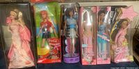 Full view of all five Barbie dolls in various original boxes, showing condition and styles